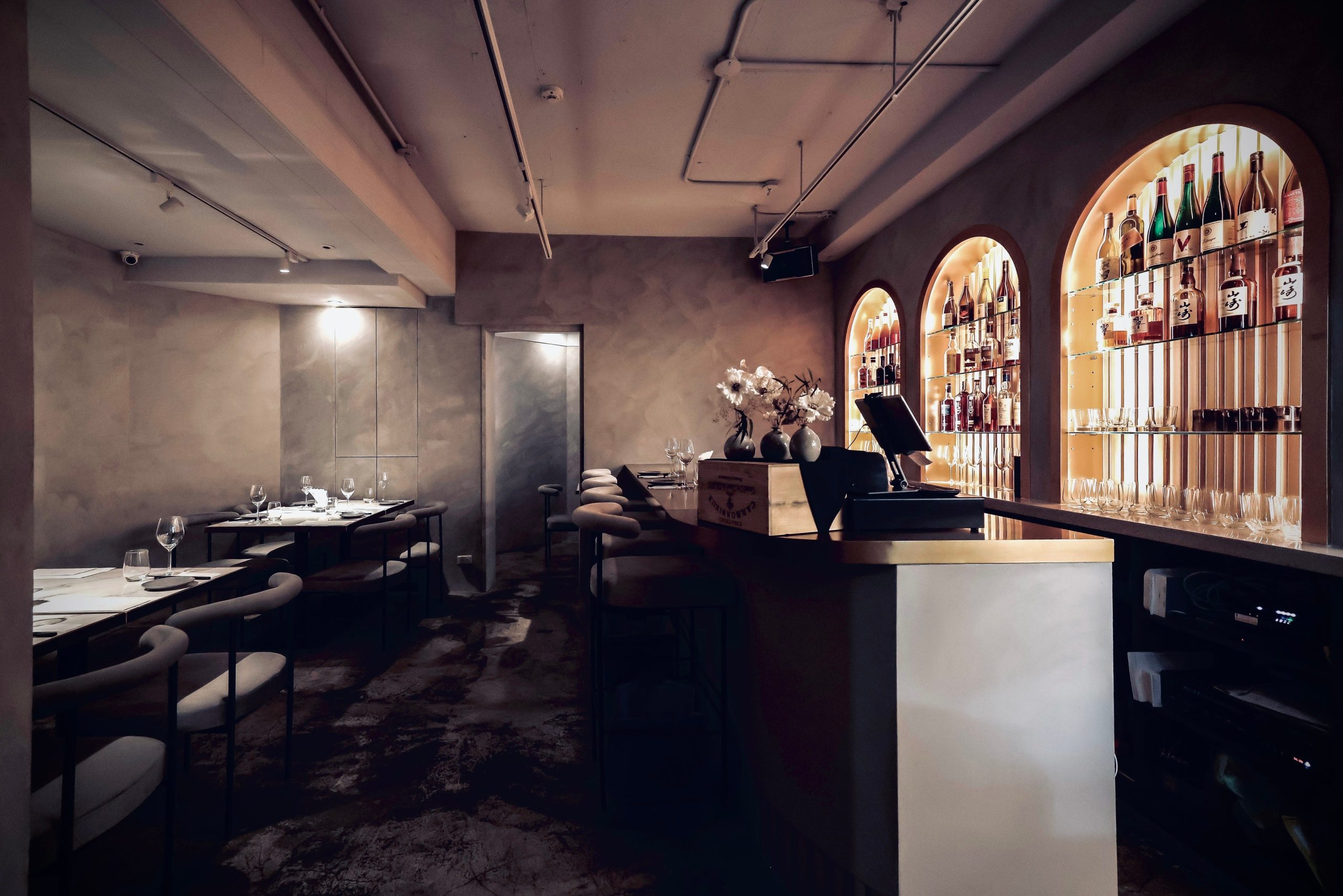 modern restaurant interior featuring a bar with shelves of bottles